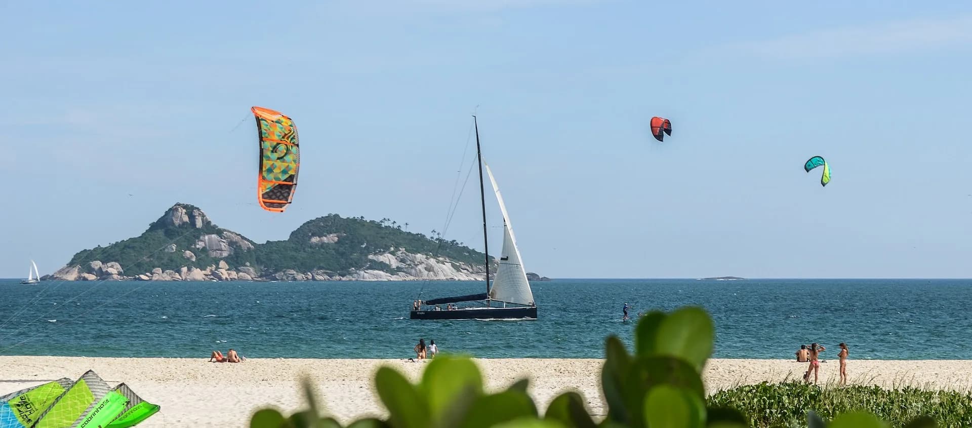 Kites flying over Barra beach with the Tijucas islands offshore