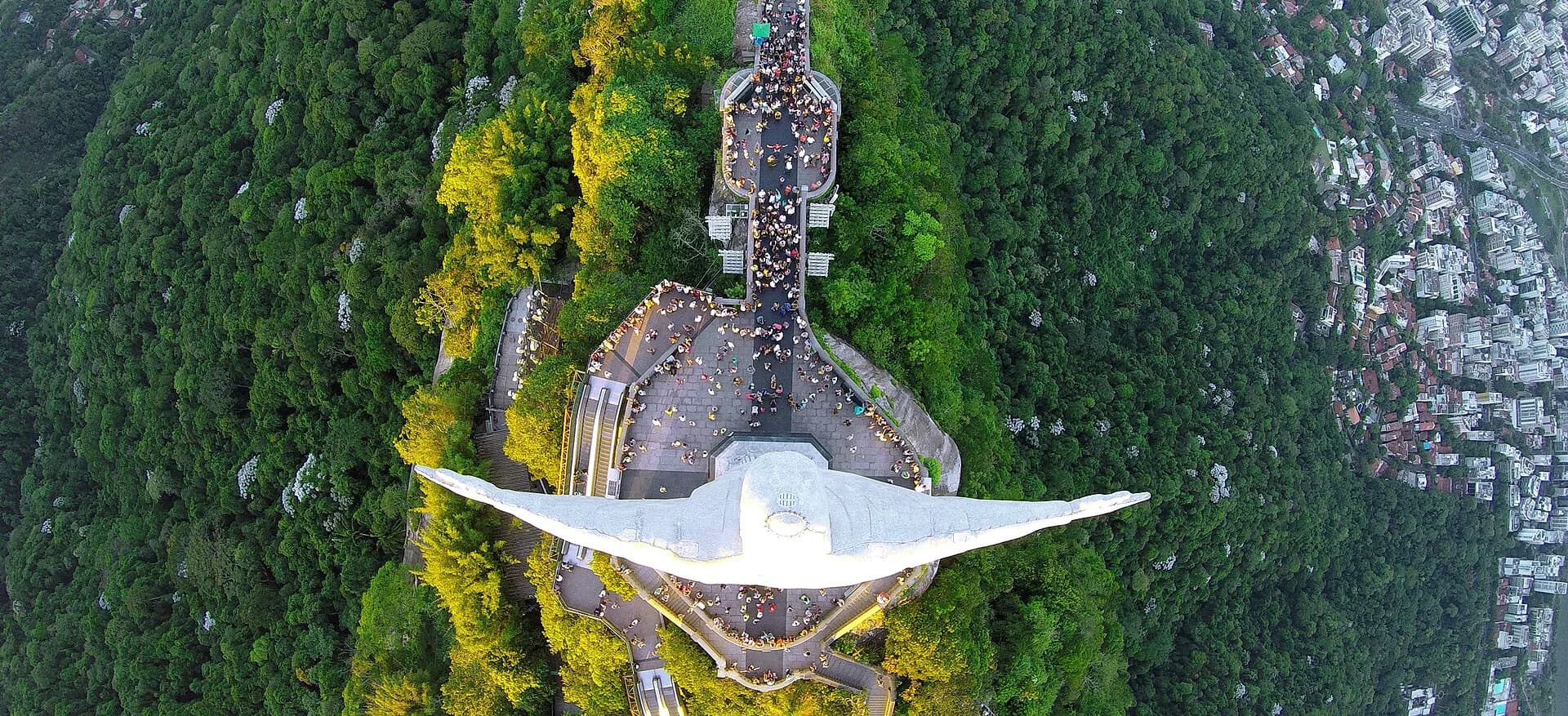 Christ the Redeemer seen from directly above, arms outstretched over the crowd