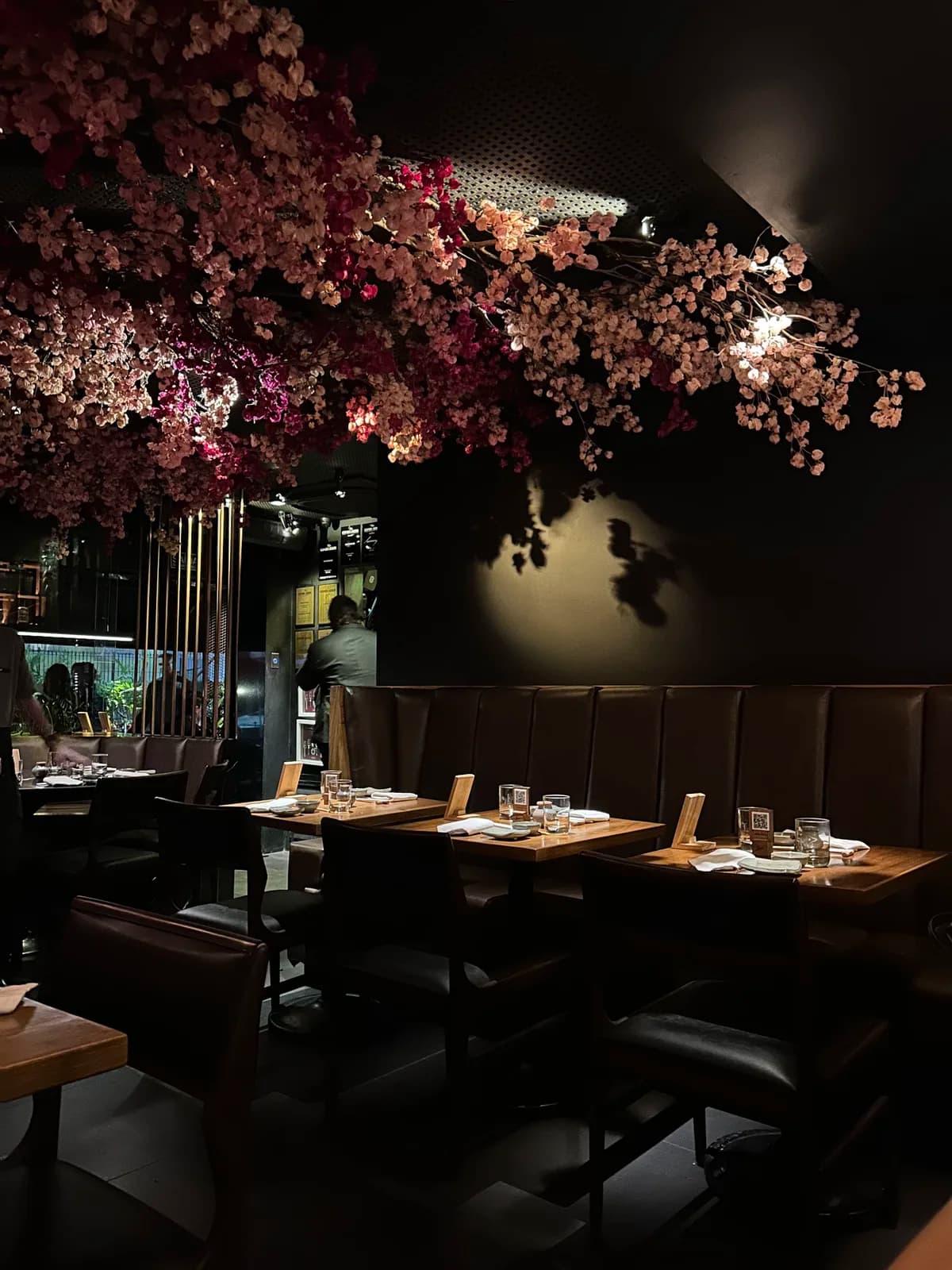 San Leblon's dark dining room under a canopy of cherry blossoms