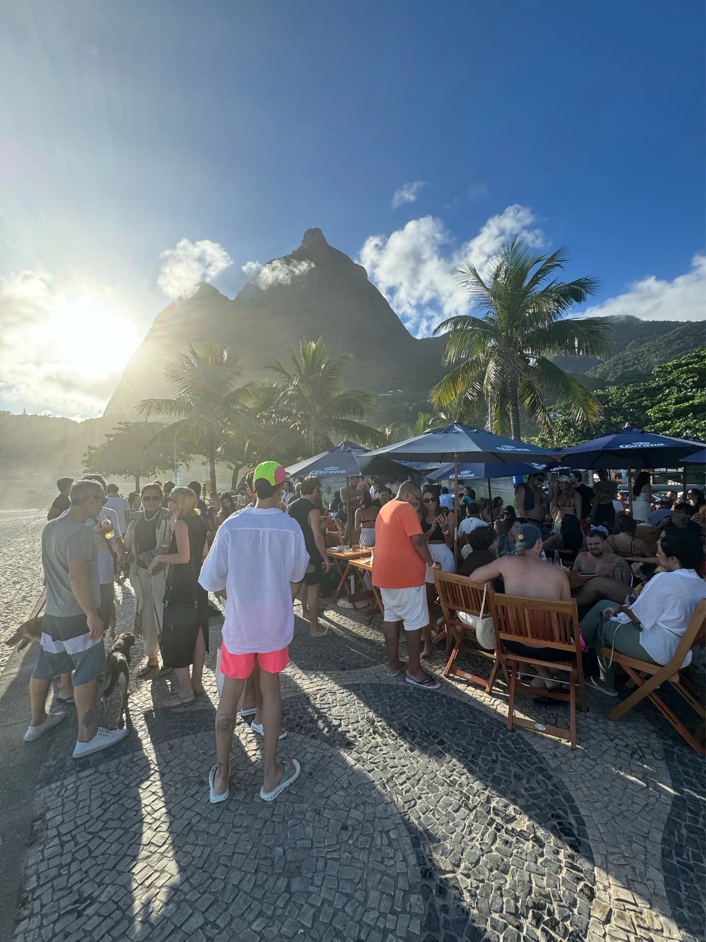 Golden-hour crowd at Soga Beach with Pedra da Gávea behind